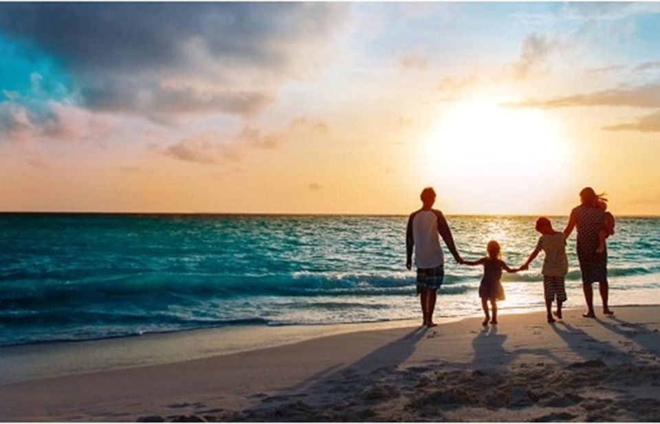 Family on beach at sunset