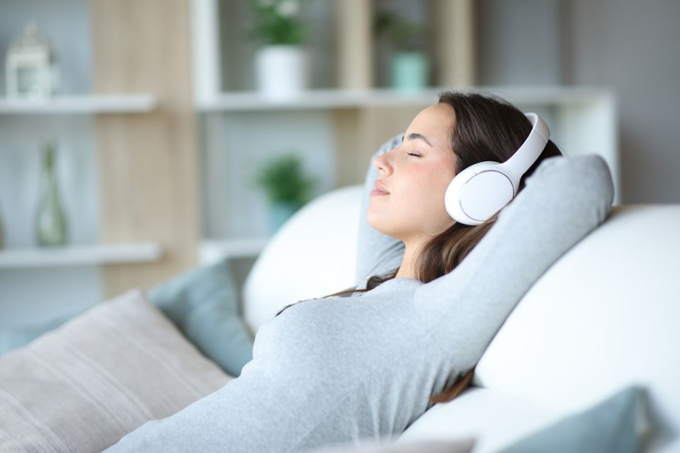 young woman relaxing on headphones