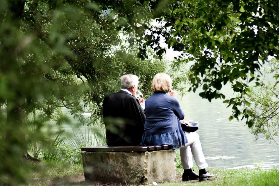 older couple picnic at lake